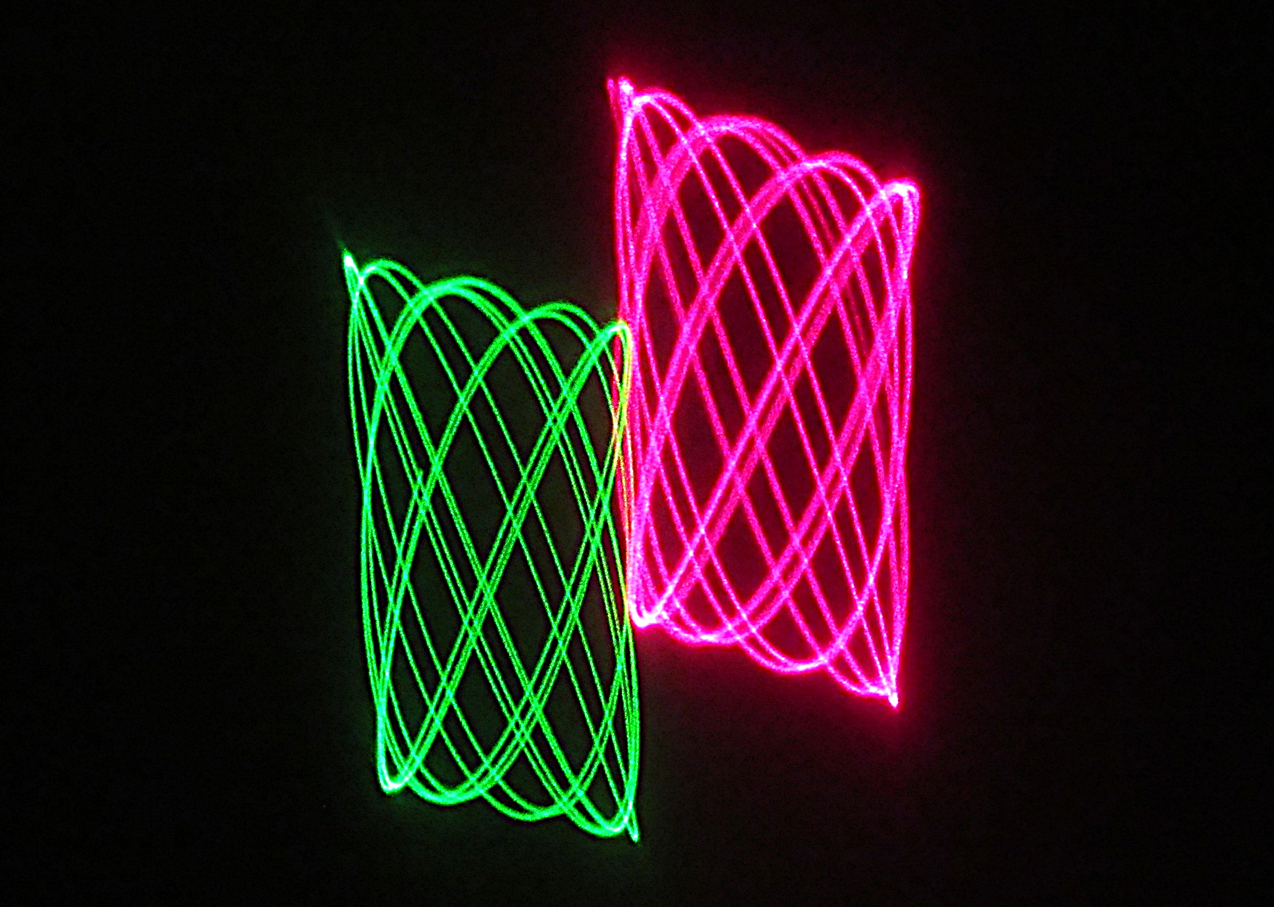 This picture shows cymatics, the study of wave phenomena, sound, and their visual representations. The patterns shown are created by a laser beam that is reflected by a small mirror onto a wall in my darkened basement. I