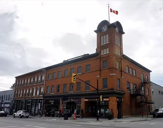 Cars parked in front of a large historical building