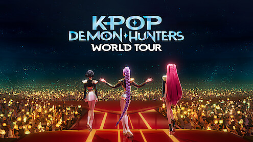 Three animated female characters stand on a stage facing a large cheering crowd with glowing lights, under a night sky, with the title "K-Pop Demon Hunters World Tour" above them.
