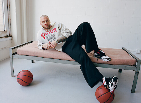 Chet Hanks on cot with basketball