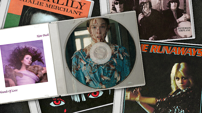 A collection of music album covers with a CD case in the center, featuring a woman in a floral dress with blood on her face, all laid out on a flat surface. Includes albums by Kate Bush, The Runaways, Natalie Merchant, and Jefferson Airplane.