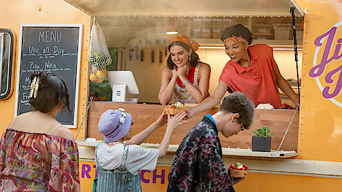Zoey Deutch as Jill and Megan Danso as Zella sell dessert nachos at a food truck in 'Voicemails for Isabelle'