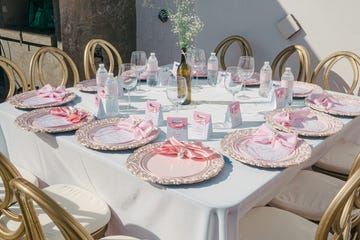 elegant table setting with pink and gold accents and floral centerpiece.