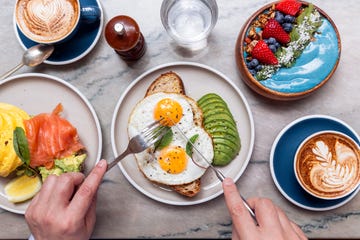 Person eating healthy colourful breakfast at a cafe, high angle view