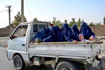topshot afghan burqa clad women travel on a mini truck along a road on the outskirts of taloqan in afghanistans takhar province on july 29, 2026. (photo by wakil kohsar / afp via getty images)