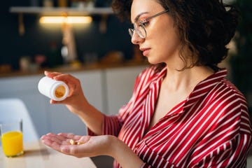 young woman taking medicines