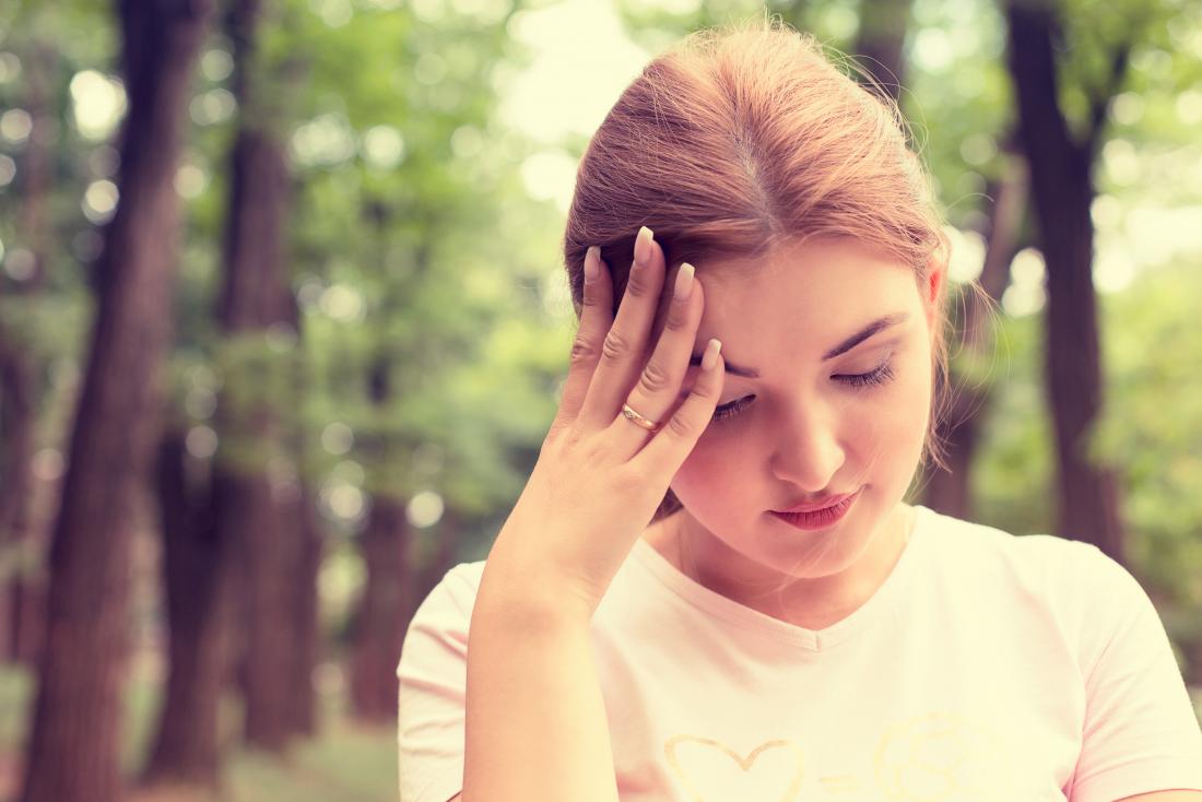 Woman holding her head and wondering why am I dizzy