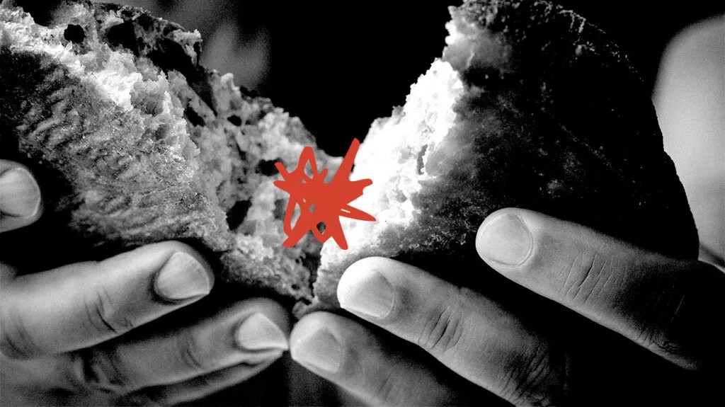 hands breaking bread