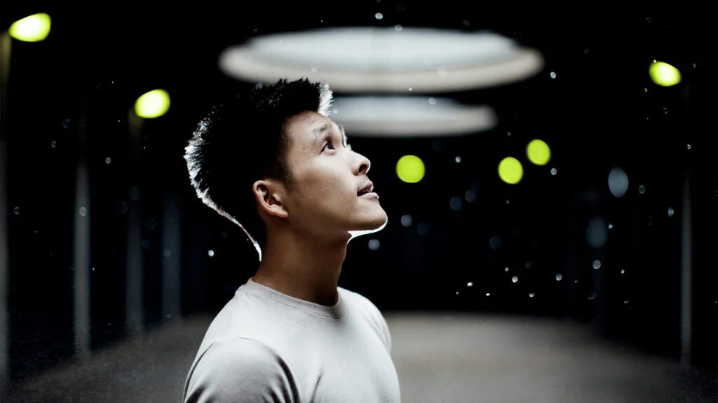 a man looking up into raindrops which are being used to represent beta blockers for anxiety