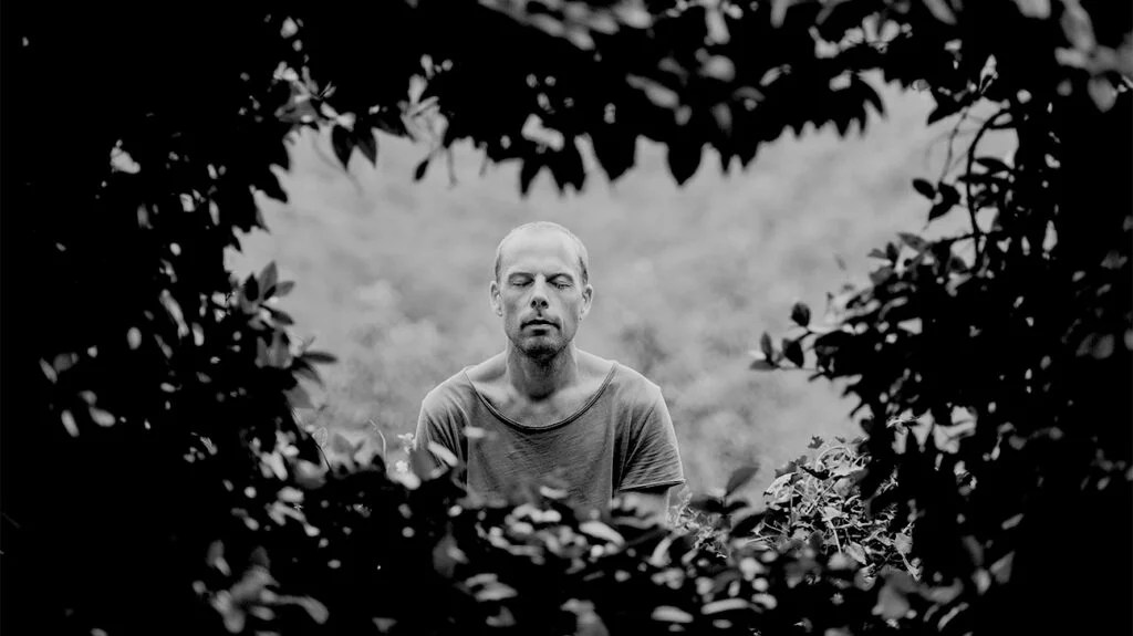 a man doing some deep breathing outside as a way to cope with anxiety