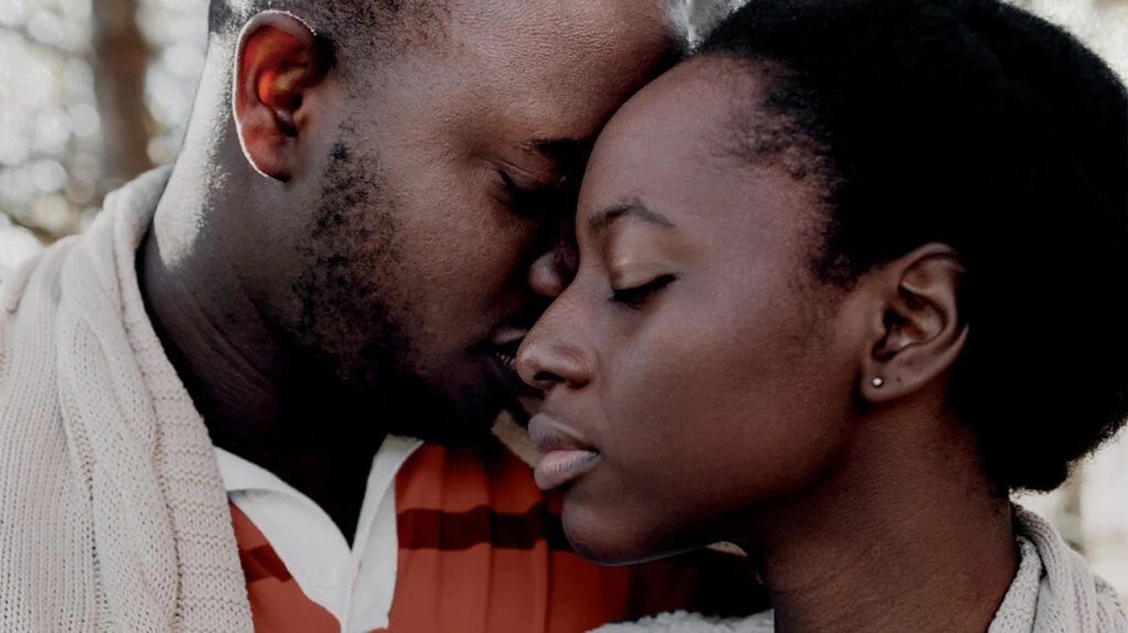 a black couple with anxiety share a hug
