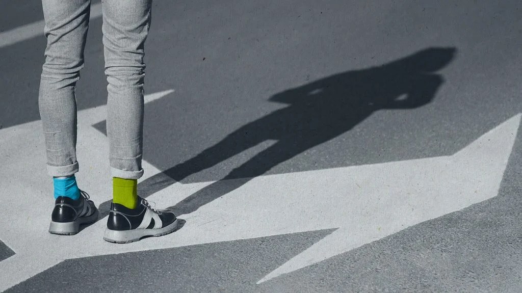 a person is looking at their shadow