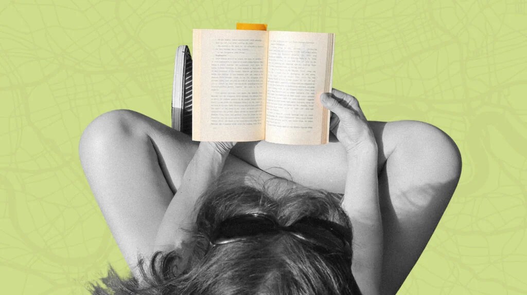 Overhead shot of a person sitting cross legged reading anxiety books