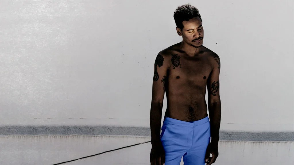 a topless man representing skin cancer in black people 