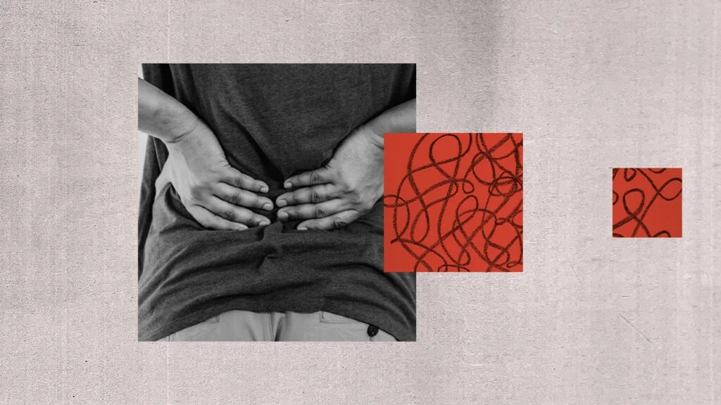 person with hands on their lower back