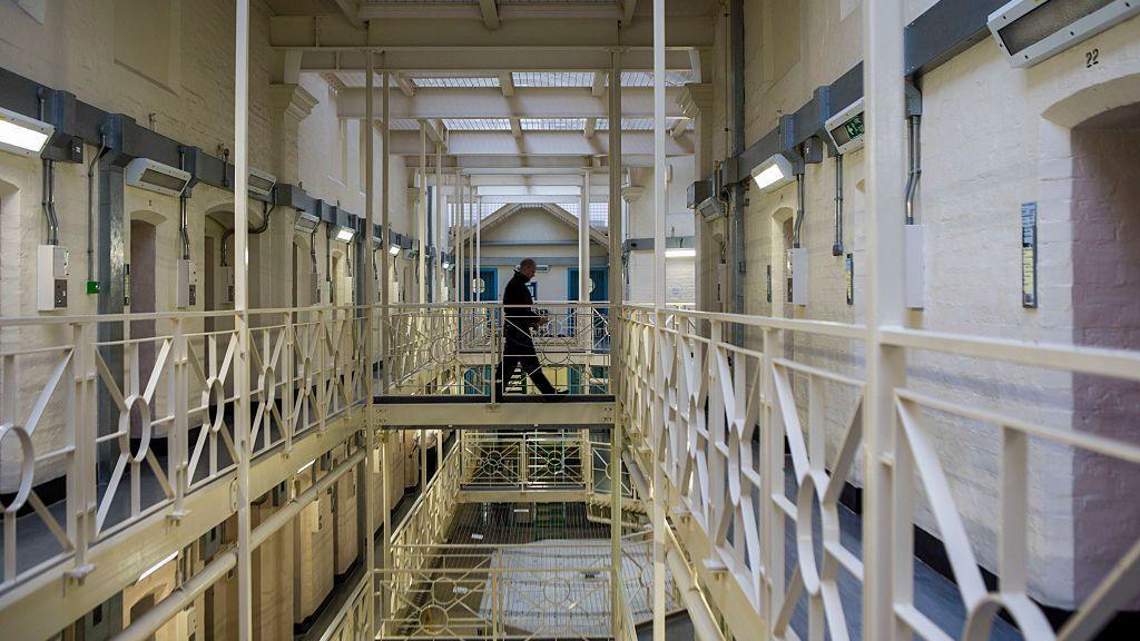A prisoner officer walks along a balcony in HMP Portland,  Dorset.
