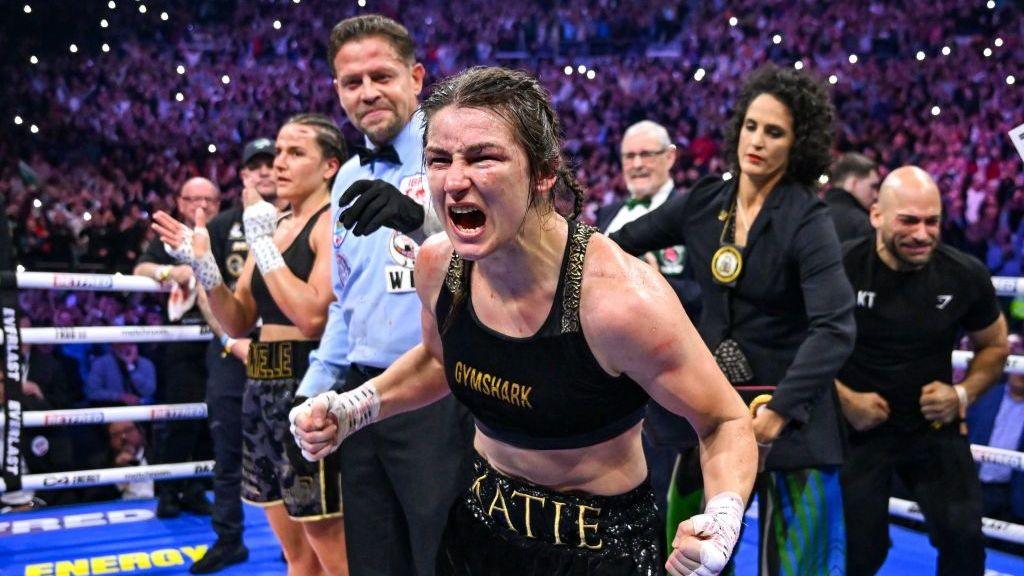 Katie Taylor celebrates her victory over Chantelle Cameron in the ring after the scorecards are announced 