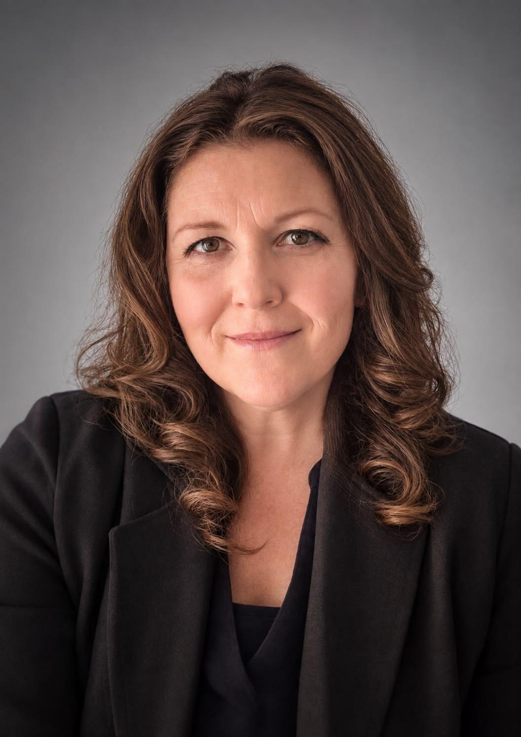 Headshot photograph of Helen Roberts who has brown shoulder length hair and brown eyes. 