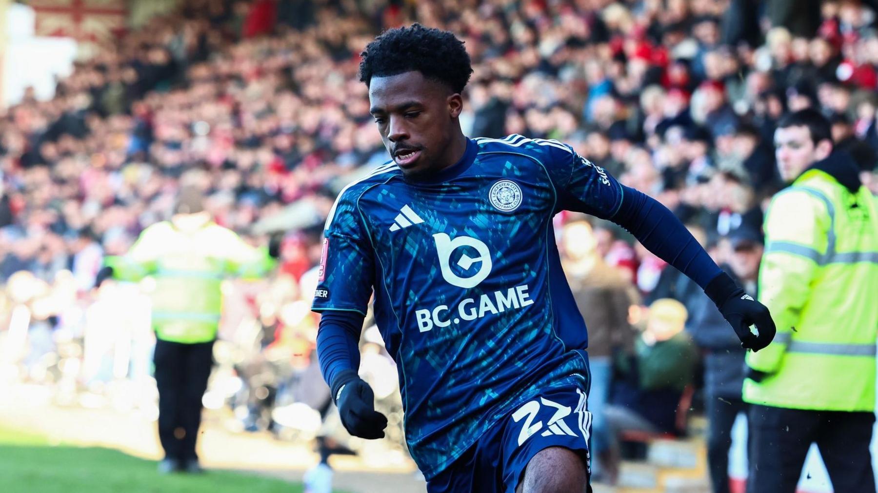 Wanya Marcal looks towards the ground as he runs on the pitch during a match for Leicester City