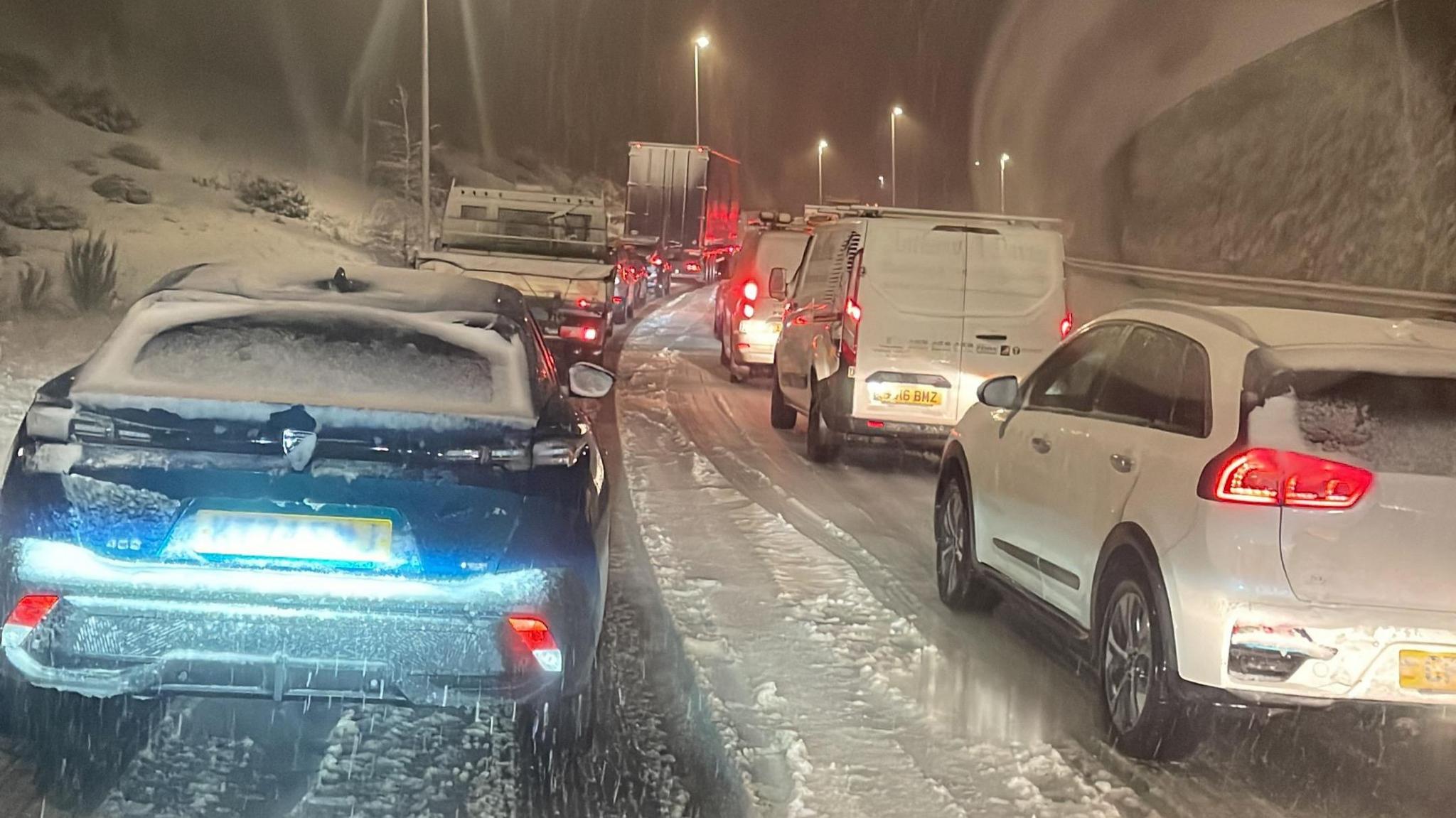 Cars in traffic jam in blizzard conditions on the A465 heads of the valleys road near Ebbw Vale