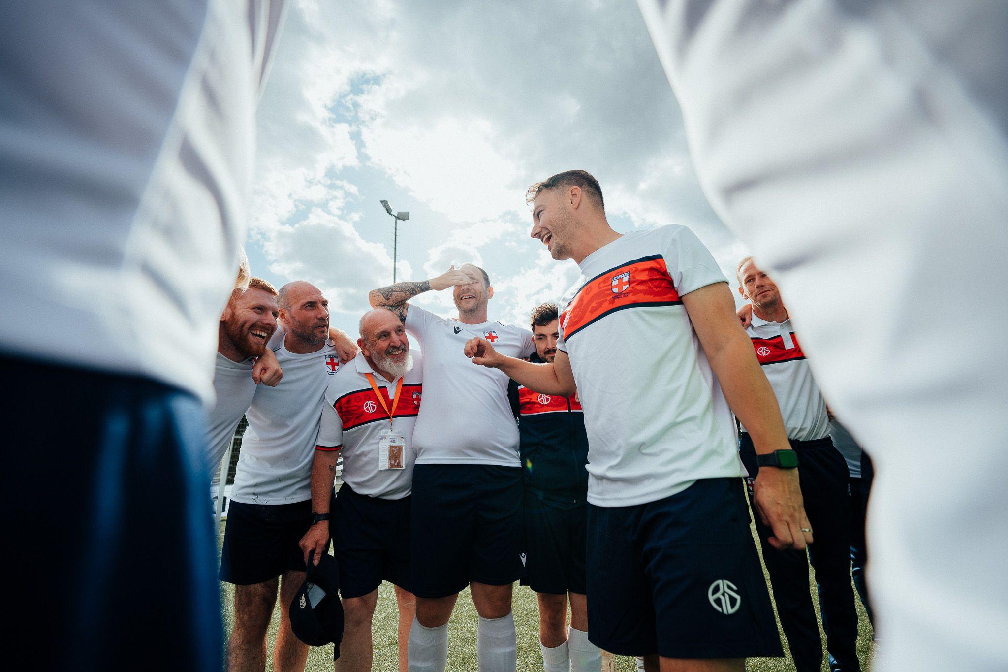 Daley Cross, England transplant team manager, speaks to his players in a huddle after the Transplant World Cup final