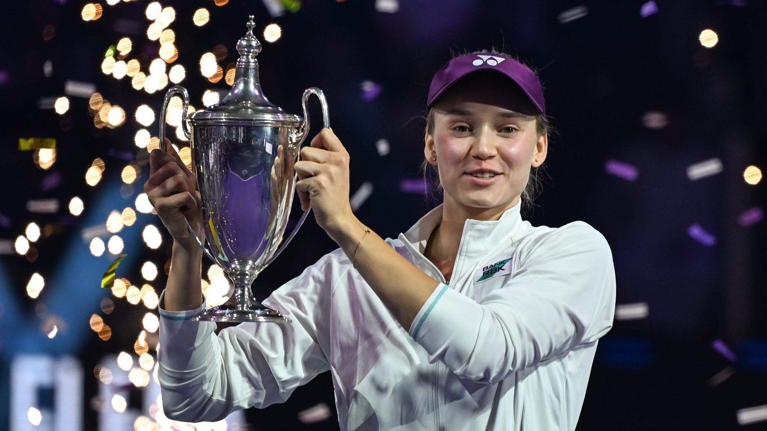 Elena Rybakina holds up the 2025 WTA Finals trophy