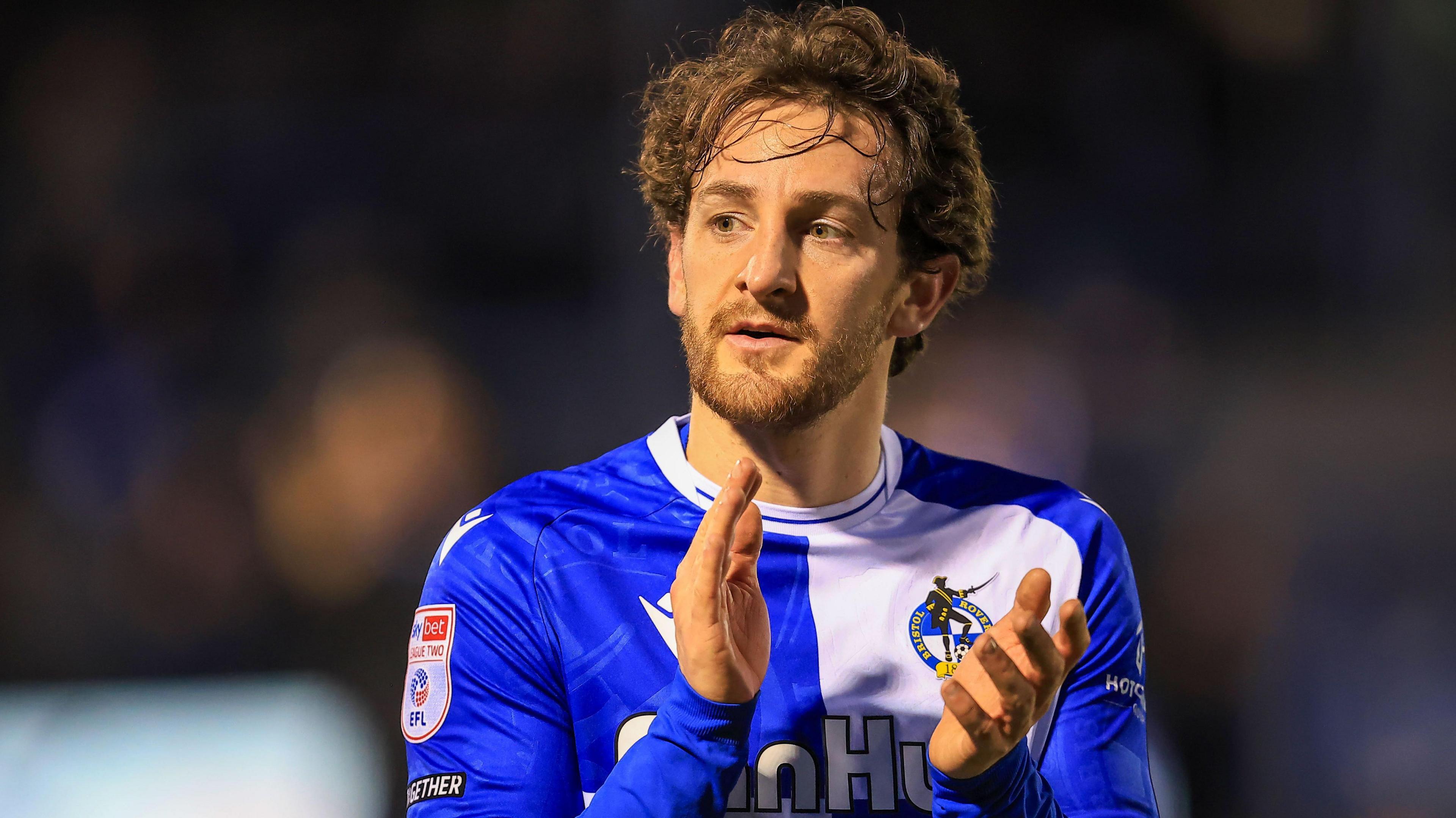 Tom Lockyer clapping while wearing a Bristol Rovers shirt