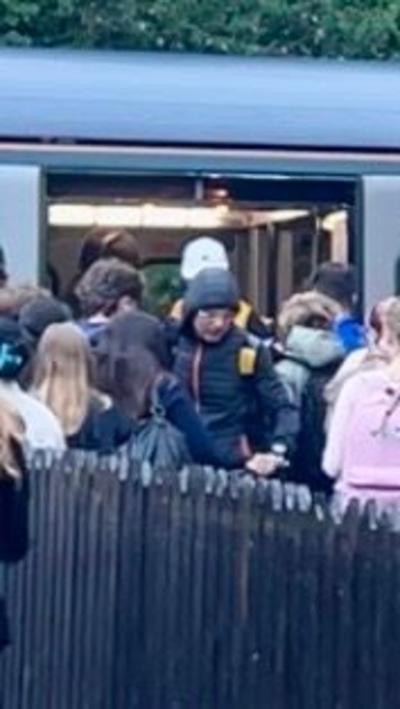 A group of young people trying to board the train from Barnstaple