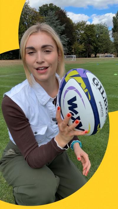 Reporter holds size 4.5 rugby ball