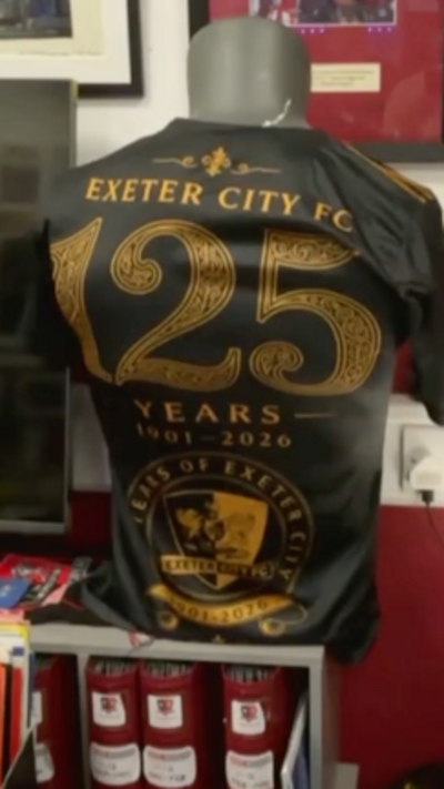A black football top that says "Exeter City FC 125 years"