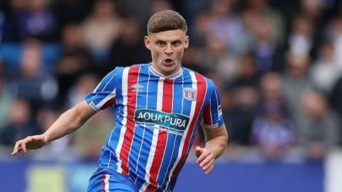 Regan Linney playing for Carlisle United in last season's kit
