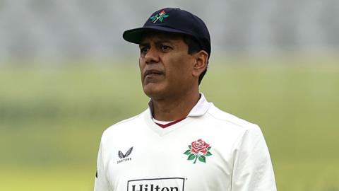 Noman Ali in whites and wearing a navy Lancashire cap