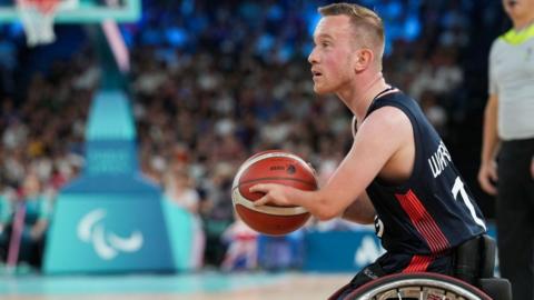 Gregg Warburton of Great Britain in action as he holds the ball while in his wheelchair