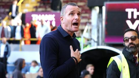 An animated Nicky Hayen shouts to Burnley fans with his hand over his chest