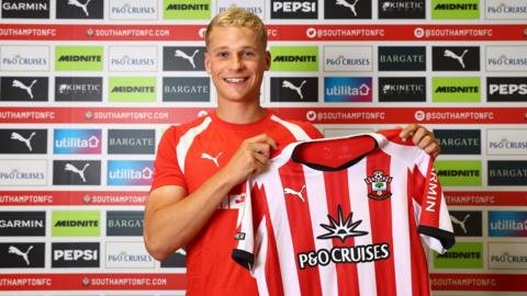  Zach Abbott poses for a photo with a Southampton shirt