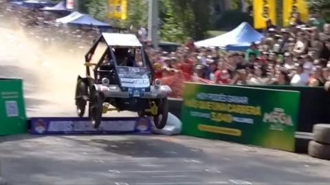 Soapbox car in air after jumping a ramp