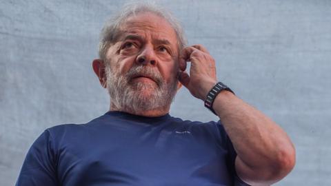 Former President Luiz Inacio Lula da Silva gestures to supporters