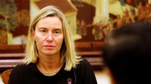 Federica Mogherini wearing a black top, an earpiece