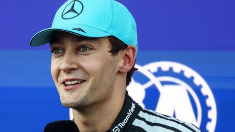 Mercedes driver George Russell smiles after taking pole position for the Azerbaijan Grand Prix