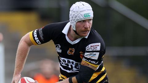 Hunter Ward passes the ball to his left for Newport
