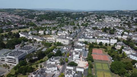 A picture taken from above looking down at a number of properties and sports fields.