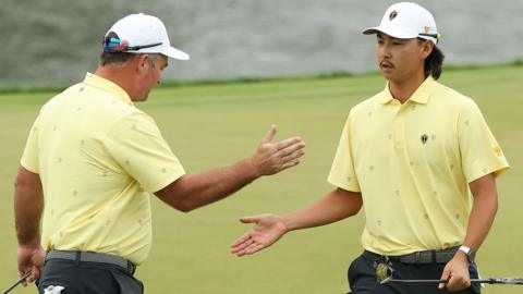Ryan Fox of New Zealand and the International Team and Min Woo Lee of Australia give each other a high five
