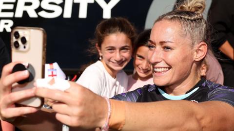 Natasha Hunt takes photo with fans