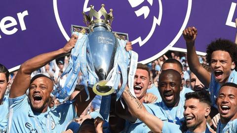 Manchester City players lifting the Premier League trophy in 2018