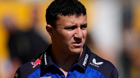 Isack Hadjar wearing a Red Bull polo shirt