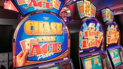 Three slot machines in a row.