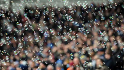 Bubbles float around Upton Park with a photo of the crowd in the background during West Ham's game against Millwall in 2012