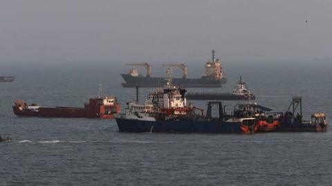 File photo showing commercial ships anchored in the Strait of Hormuz, off the coast of Bandar Abbas, Iran (10 August 2026)