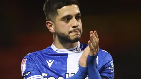 Ruel Sotiriou applauds the Bristol Rovers fans after a match