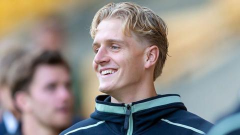  Pelle Mattsson in a navy and turquoise Norwich City training jersey.